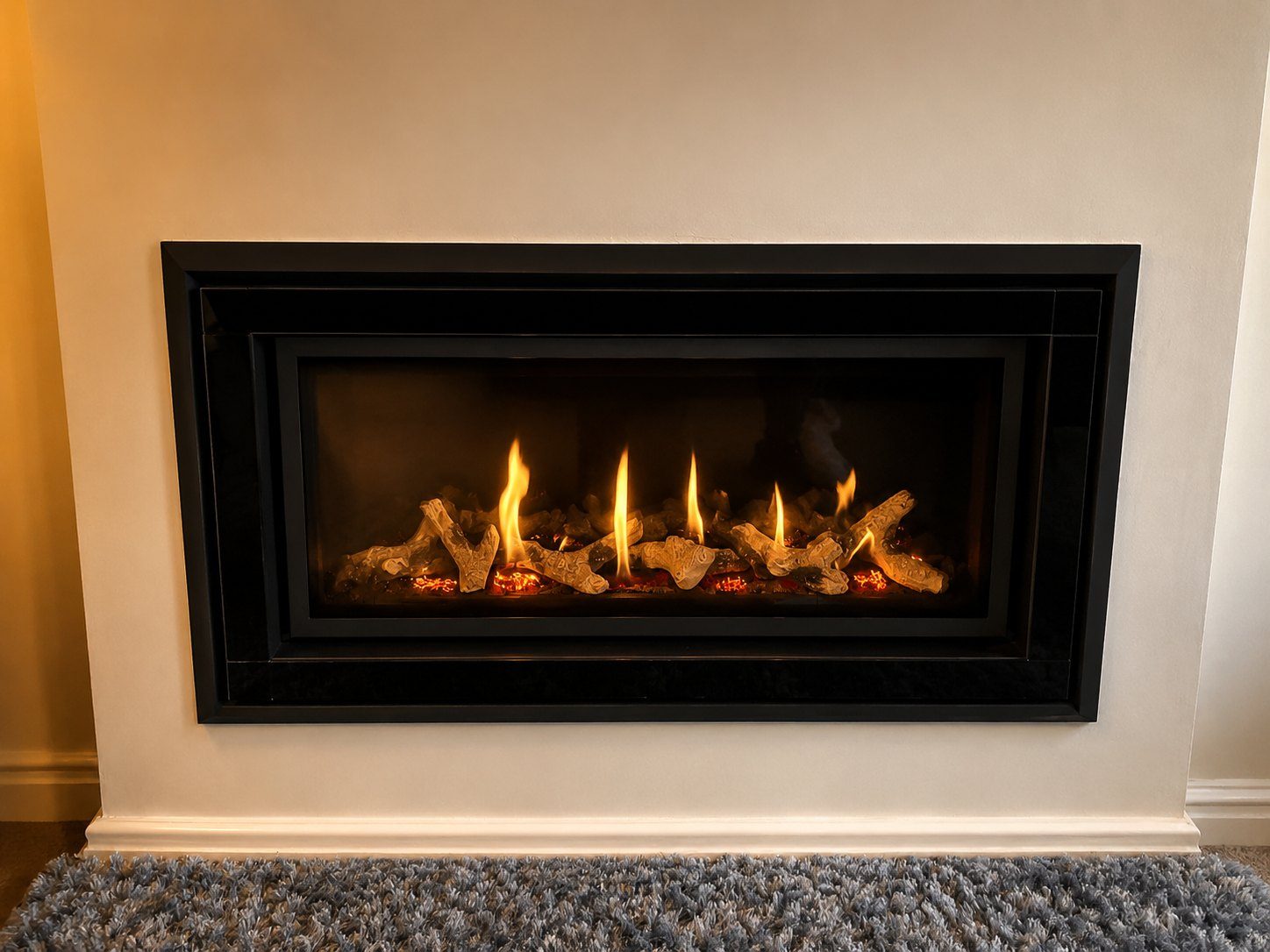 A marble-surround fireplace with living flames